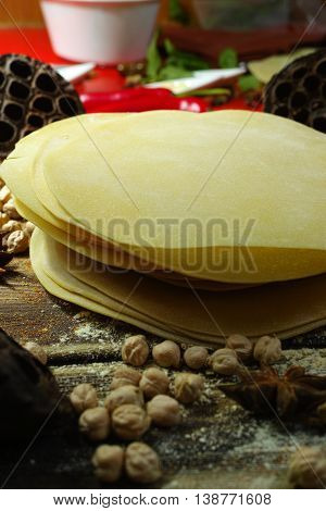 Colorful Indian food - papadum chickpea gram flour and spices on textured wooden table top
