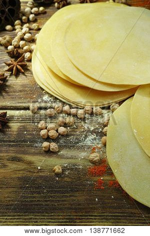 Colorful Indian food - papadum chickpea gram flour and spices on textured wooden table top