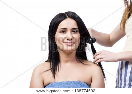 Young woman getting hair straightner isolated on white