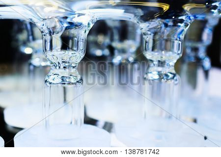 Abstract background with glass tubes. Detail of a Soxhlet extractor. Chemical laboratory equipment.