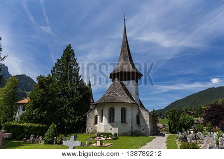 Church with wooden roof and cemetery in Rougemont Vaud canton of Switzerland