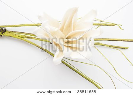 Elegant spring flower fake gardenia on rustic wooden table. For wedding background image.