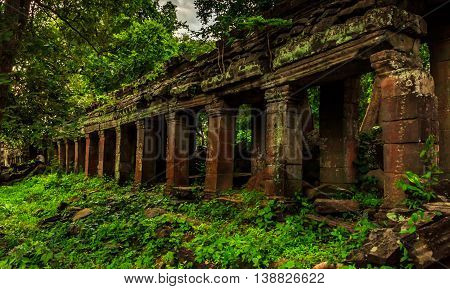 Crumbling ancient Khmer runis in the green jungle of Cambodia