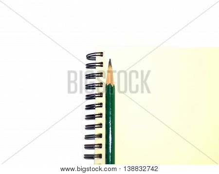 green pencil on a plain ring binder notebook right alignment