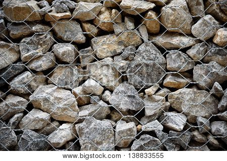 Stone with wire mesh for protection rock falling from mountain