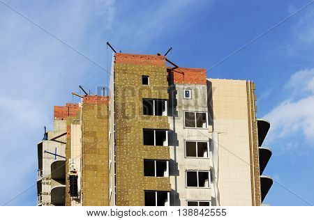 construction suspended cradle without workers on a newly built high-rise building in Moscow