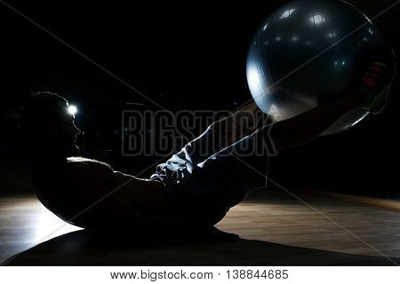 Male Fitness Model Doing Sit Ups And Crunches Exercising Abdominal Muscles, Six Pack Visible Wearing