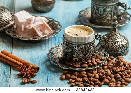 Turkish coffee and turkish delight with traditional embossed metal tray and cup