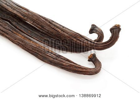 Organic dry sticks of Vanilla (Vanilla planifolia) isolated on white background. Macro close up. Top view.