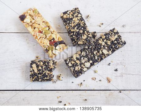 Healthy granola. Organic munchies bars on wooden background.