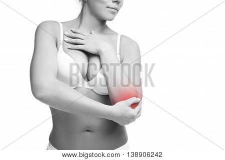 Young caucasian woman in bra with pain in elbow ache in the human body isolated on white background with red dot copy space