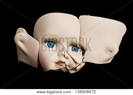 Broken Doll Face and Head on Black Background