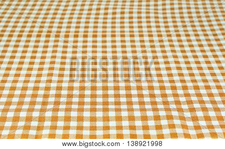 Wooden table covered with tablecloth. View from top. Empty tablecloth for product montage. Free space for products and for your text