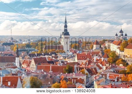 Aerial view of the tiled roofs, spiers and streets in the historical part of old Tallinn.