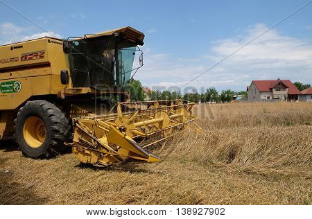 TRNOVEC, CROATIA - JULY 09, 2016: Combine harvester harvest ripe wheat on a farm in Trnovec, Croatia on July 09, 2016