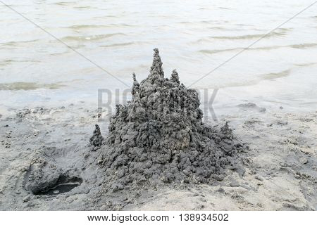 Castle of black sand on the lake