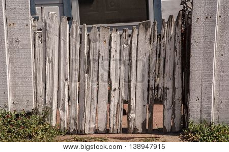 Old Picket Concave Closed  Fence Gate With Peeled White Paint