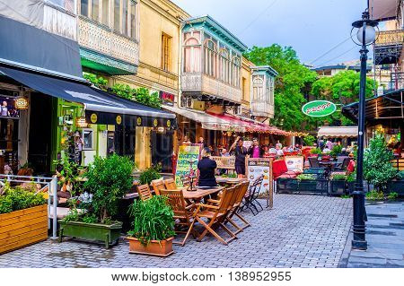 TBILISI GEORGIA - MAY 28 2016: The narrow streets boast the nice cafes and restaurants for each taste on May 28 in Tbilisi.