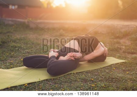 woman practicing outdoors meditating in yoga position
