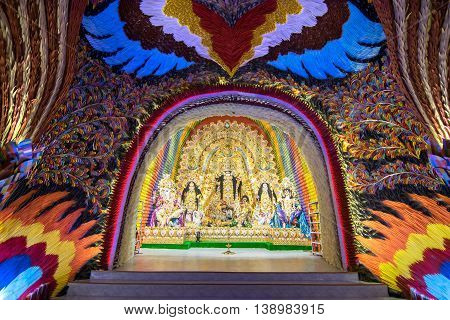 KOLKATA INDIA - OCTOBER 18 2015 : Night image of decorated Durga Puja pandal shot at colored light at Kolkata West Bengal India. Durga Puja is biggest religious festival of Hinduism.