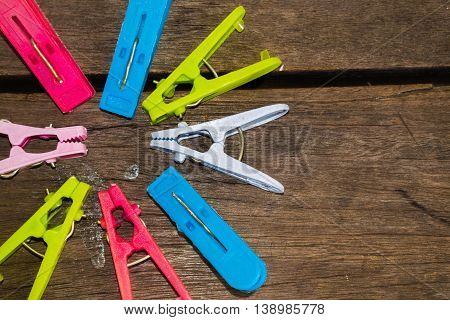 Colorful clothes peg, clothespin on wood background use for dry the clothes under the sun