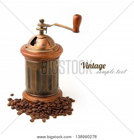 Vintage coffee grinder and coffee beans on white background