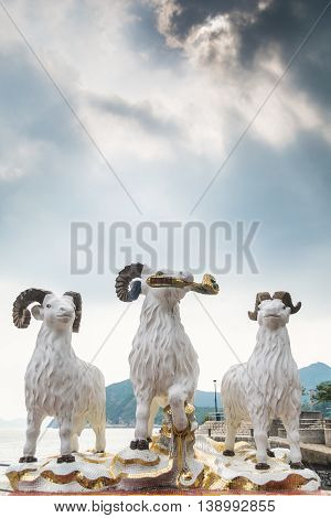 REPULSE BAY HONG KONG - MAY 23: The statues of three celestial rams with sunlight comes through clouds like the God blesses the earth in Kwun Yam temple on May 23 2016 in Repulse Bay Hong Kong.