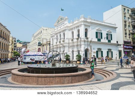 MACAU CHINA - MAY 24: Tourists and local residents walk around the Senado Square on May 24 2016 in Macau China.