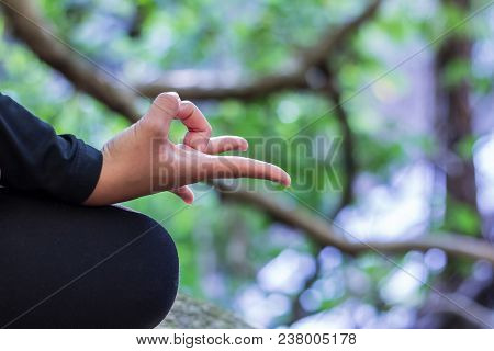 Women Practicing Yoga On Rocks In Nature.