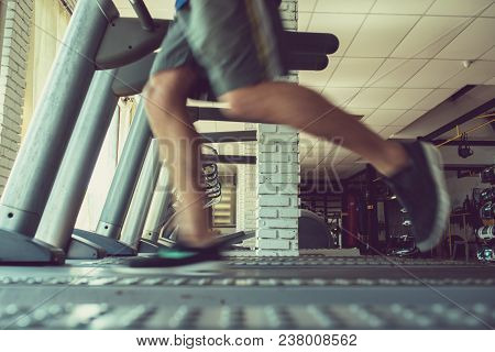 Legs Of Sportsman Running Fast On Threadmill, Blurred Motion