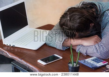 Exhausted Women Sleeping At Workplace After Hard Working Day