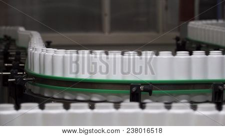 Packed Bottle Moving On Conveyor Belt. Plastic Bottle On The Conveyor.