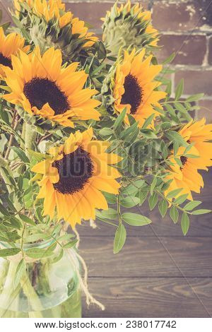 Bouquet Of Bright Sunflowers On Wooden Table. Retro Toned.