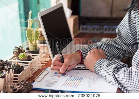 Businesswomen Is Analyzing The Graph.businesswomen Using Computer Working In Coffee Shop.
