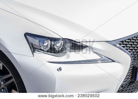 Headlight Of A Modern White Sport Car. The Front Lights Of The Car. Modern Car Exterior Details. Car