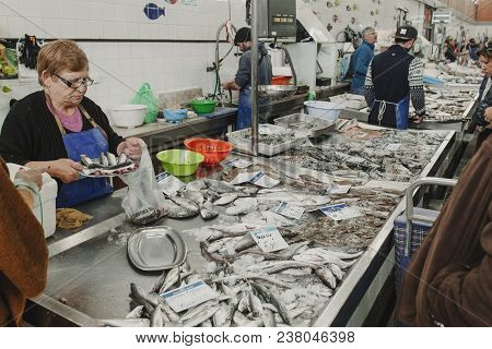March 24th, 2018 - Olhao, Portugal: Fishmonger Selling Fish To A Client At The Fish Market In Olhao,