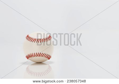 Professional Baseball On White Background. Isolated And Reflecting In The Surface Below It.