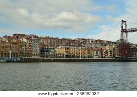View Of The Dock And Buildings Of Porugalete At Sunrise From Getxo. Architecture History Travel. Mar