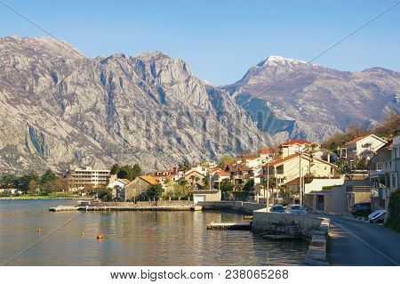 Mediterranean Landscape. Montenegro, Bay Of Kotor,  View Of Embankment In Stoliv Village And Snow-ca