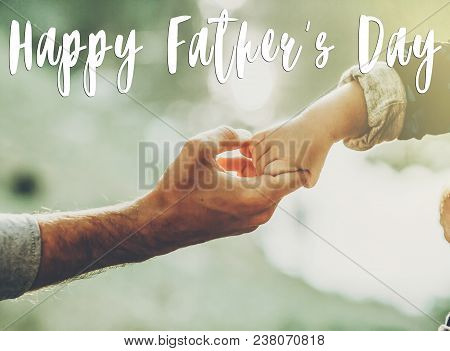 Happy Father's Day Text, Greeting Card Concept. Father And Little Son Holding Hands In Sunlight In S