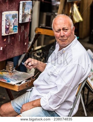Paris, France - July 06, 2017: The Painter Works At The Open Air Artist Market At The Tertre Square 