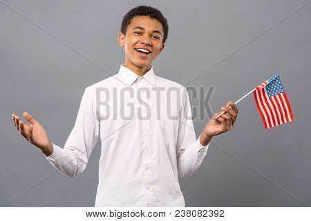 American Citizen. Joyful Nice Man Smiling While Holding The Us Flag