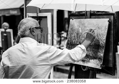 Paris, France - July 06, 2017: The Painter Works At The Open Air Artist Market At The Tertre Square 