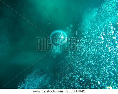 Air boobles in blue sea water. Maldives.