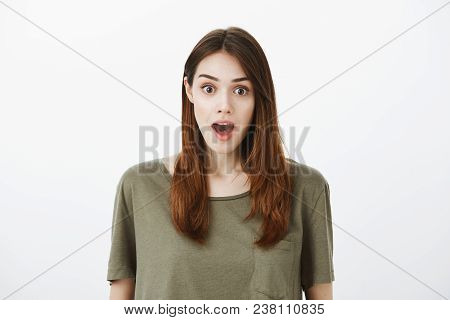 Amazed Good-looking Mature Female Coworker In Trendy T-shirt, Dropping Jaw From Surprise And Gazing 