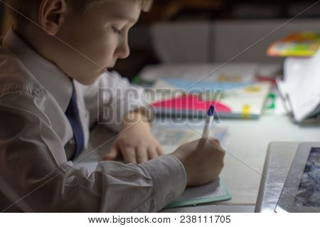 Home Education. Boy Hand With Pen Writing English Words By Hand On Traditional White Notepad Paper. 