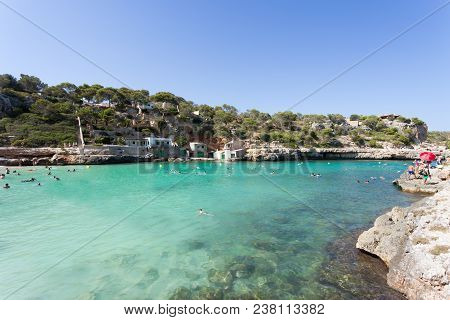 Cala Llombards, Mallorca, Spain - August 2016 - People Swimming At The Beach Of Cala Llombards