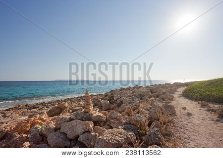 Cap De Ses Salines, Mallorca, Spain - A Walk During Sundown At The Rocky Beach Of Ses Salines