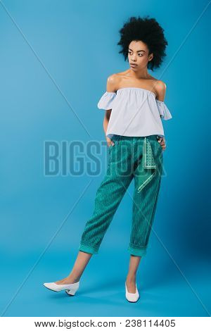 Attractive Young Woman In Stylish Off-the-shoulder Top On Blue