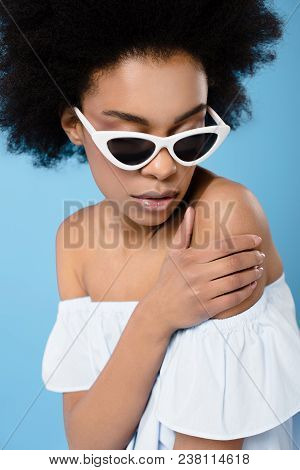 Close-up Shot Of Young Woman In Stylish Off-the-shoulder Top And Sunglasses Isolated On Blue